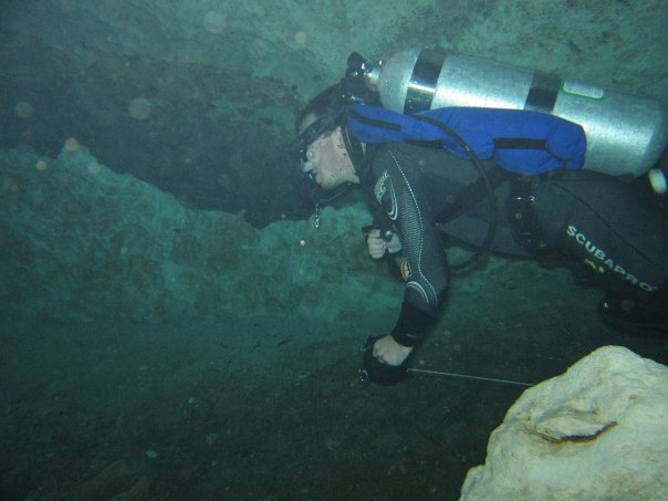 A cave diver running a reel